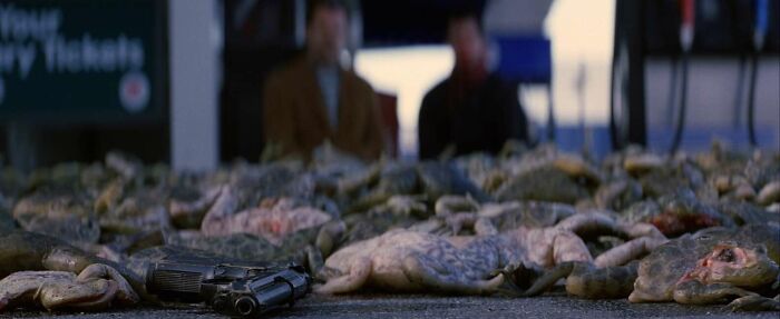 Piles of frogs and a prop gun on the ground, connected to famous movie props stories.