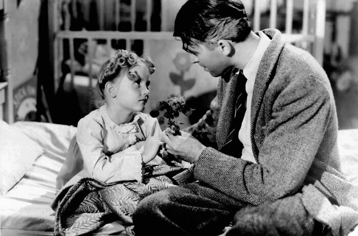 Child and adult exchanged glances, famous movie props storytelling moment, in a black and white setting.