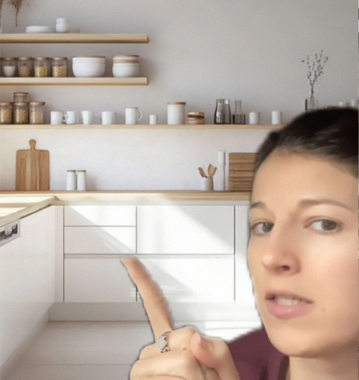 Woman pointing at stylish kitchen shelves; kitchen transformation sparks discussion. Woman pointing at stylish kitchen shelves; kitchen transformation sparks discussion.
