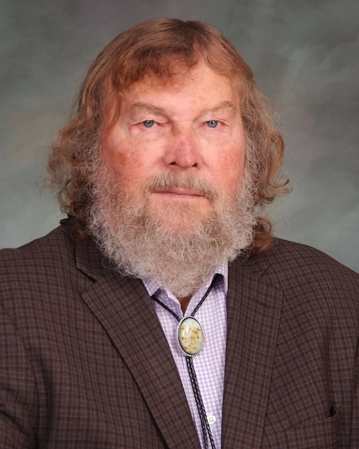 Sen. Tim French in a plaid suit with a bolo tie. Sen. Tim French in a plaid suit with a bolo tie.