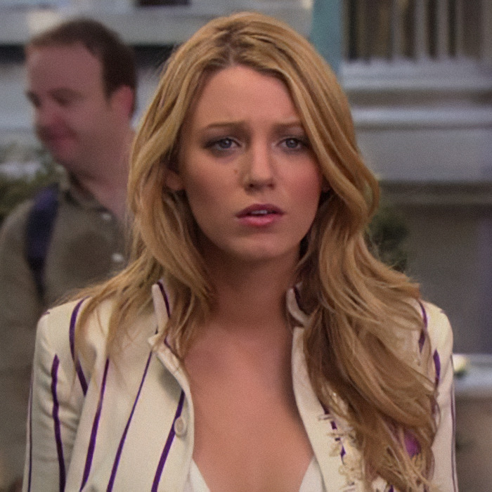 Blake Lively looking concerned in a striped blazer, outdoors in a scene from "Gossip Girl.