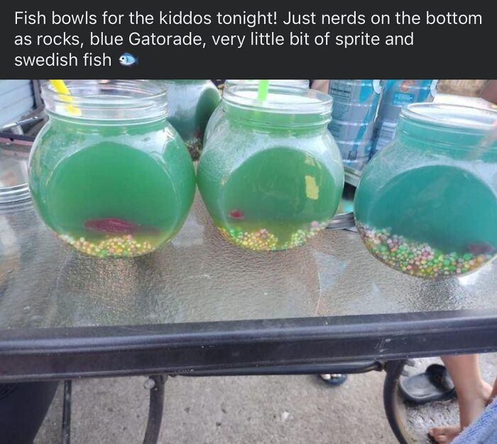 Horrendous DIY fish bowl drinks with blue Gatorade, Nerds candy, and Swedish fish on a table for craft shaming.