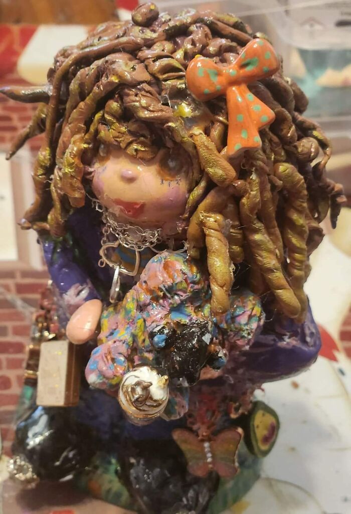 Horrendous DIY project sculpture with chaotic colors and a bow on top, showcasing an example of craft shaming.