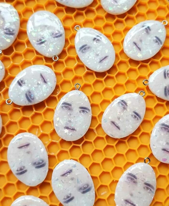 Bad DIY project featuring resin charms with faces on a yellow honeycomb pattern.