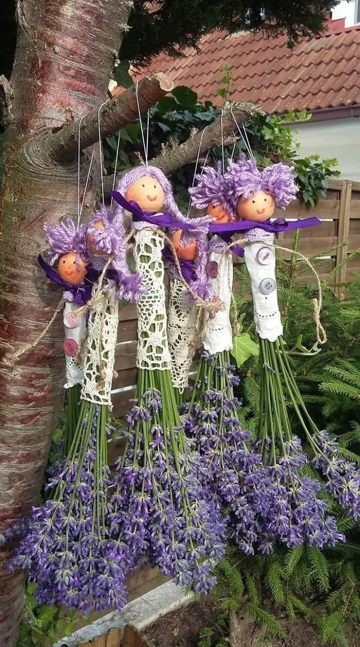 Craft shaming DIY project with dolls made from lavender and yarn, hanging on a tree branch.