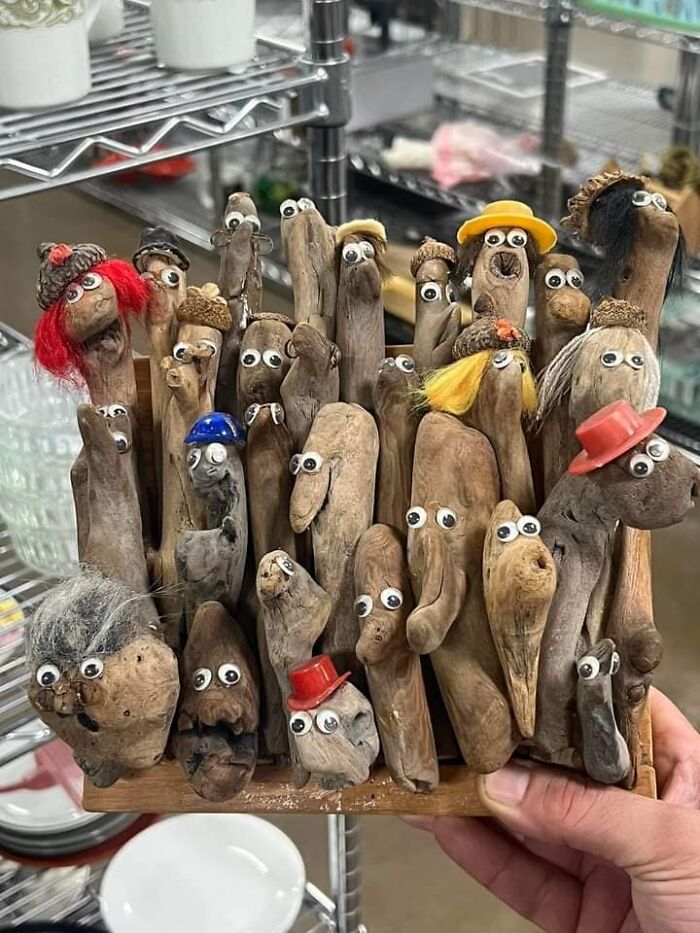 DIY craft project with driftwood figures wearing googly eyes and small hats, highlighting horrendous DIY creativity.