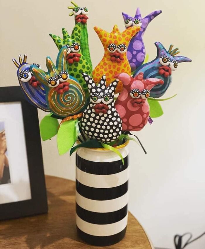Quirky DIY craft project featuring colorful, whimsical fabric creatures in a striped vase.