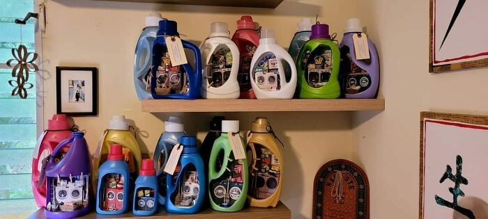 DIY project using colorful detergent bottles as photo frames on shelves, showcasing a unique crafting concept.
