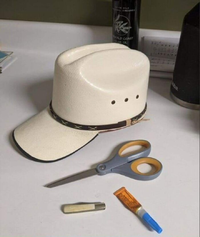 DIY project hat with scissors and glue on a table, showcasing a craft fail.