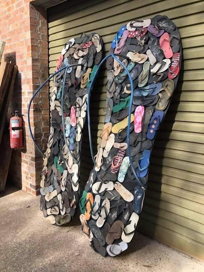 Giant flip flops crafted from numerous smaller sandals, showcasing a bizarre DIY project.