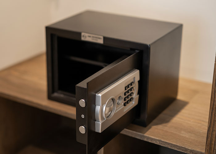 Open hotel room safe with electronic keypad, reflecting housekeepers' discoveries during room cleaning.