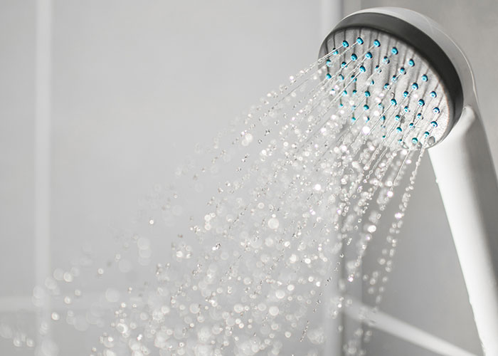 Showerhead with water spray, related to hotel housekeepers' experiences in rooms.