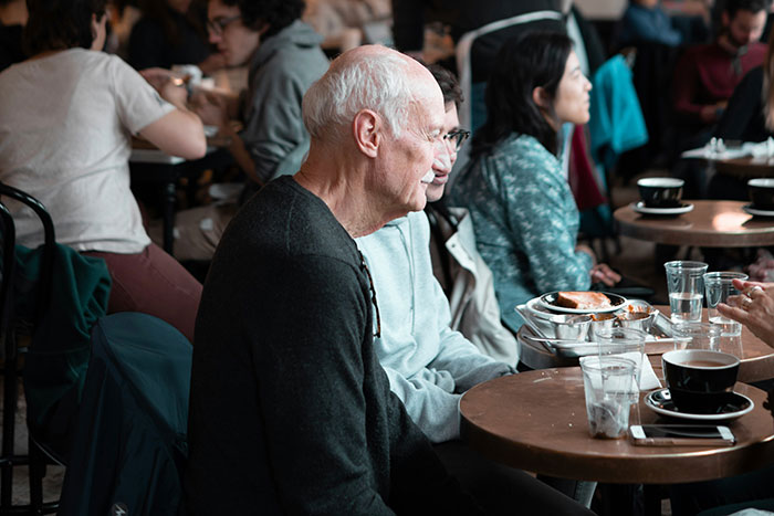 People sitting at tables in a bustling restaurant.