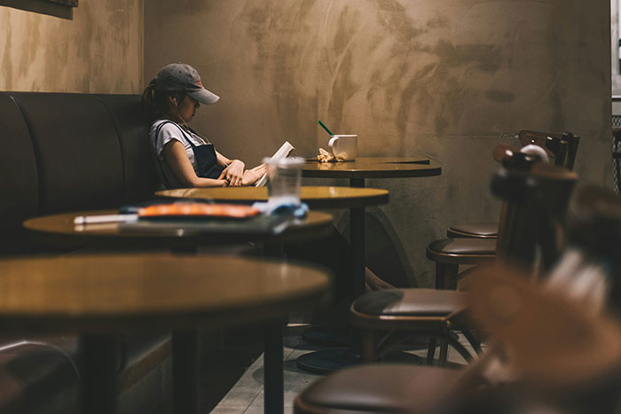 Empty restaurant with a lone diner, suggesting a bad restaurant experience.