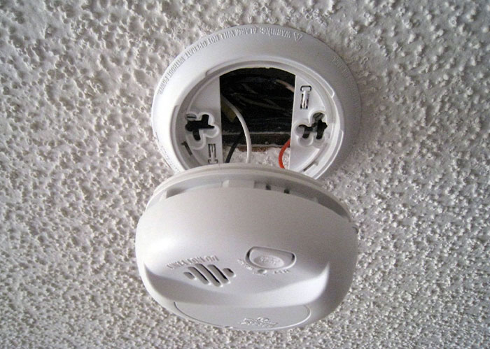Smoke detector removed from ceiling, exposing wires; relates to paranoia theme. Smoke detector removed from ceiling, exposing wires; relates to paranoia theme.