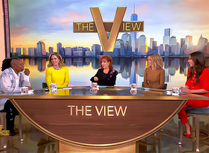 Whoopi Goldberg and co-hosts on The View set, discussing various topics. Whoopi Goldberg and co-hosts on The View set, discussing various topics.