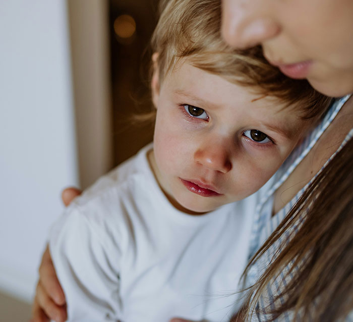 Sad child being comforted by an adult, illustrating emotional impact in stories about how to ruin your entire life.