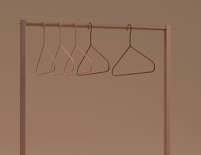 Five empty hangers on a minimalistic clothes rack, illustrating extreme frugality.