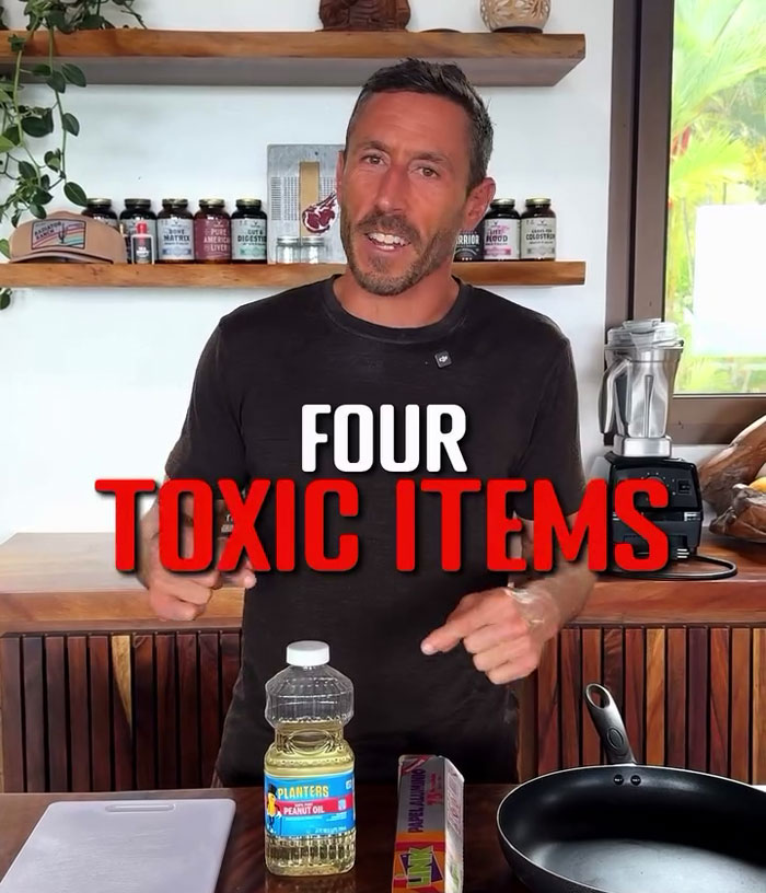 Man in kitchen pointing at four toxic items including peanut oil, surrounded by cooking ingredients. Man in kitchen pointing at four toxic items including peanut oil, surrounded by cooking ingredients.