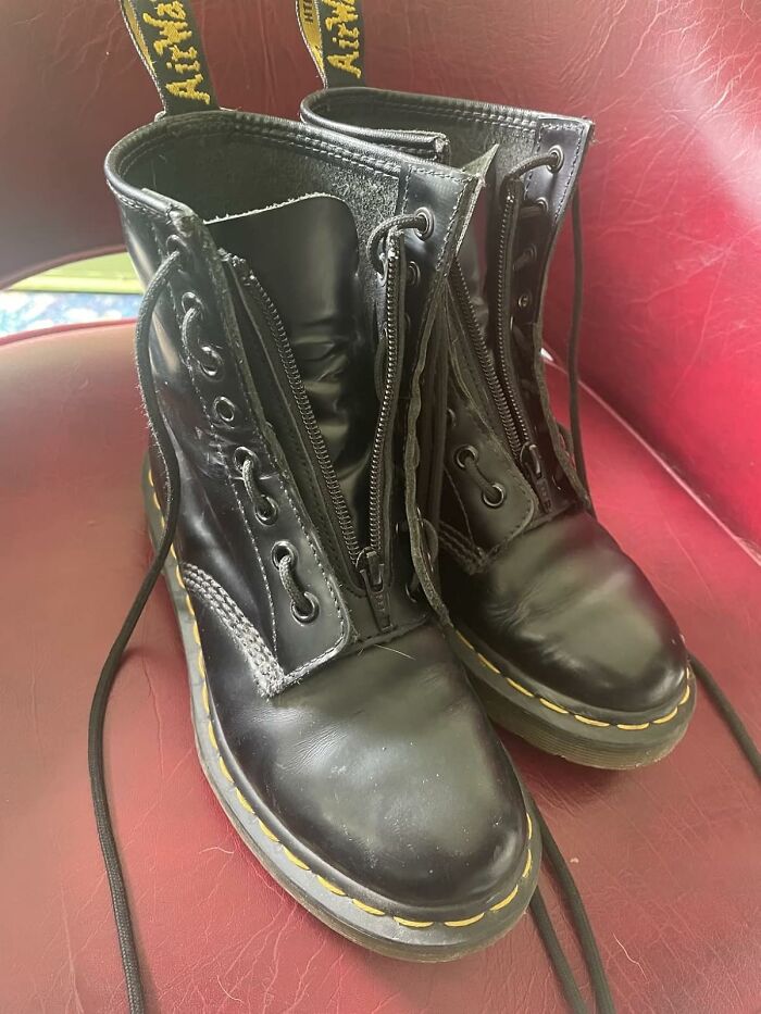 Black boots with zippers and yellow stitching on a red leather chair, showcasing a way to transform things you already own.