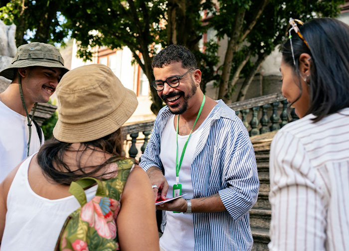 People laughing and discussing wild questions about their homeland during a casual outdoor gathering.