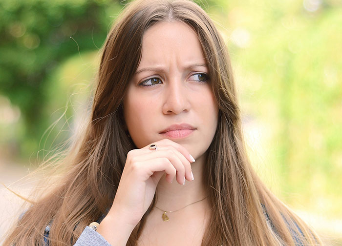 A woman with a puzzled expression, representing wild questions about their homeland's level of stupidity.