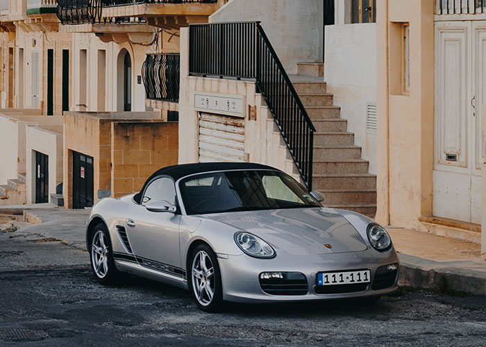 Silver sports car parked on a quiet street, ideal for getting those 10K steps in a day around the neighborhood.