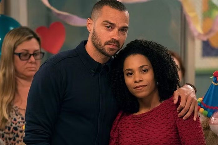 TV couple with less chemistry at a party scene, man with a beard and woman in a red top.