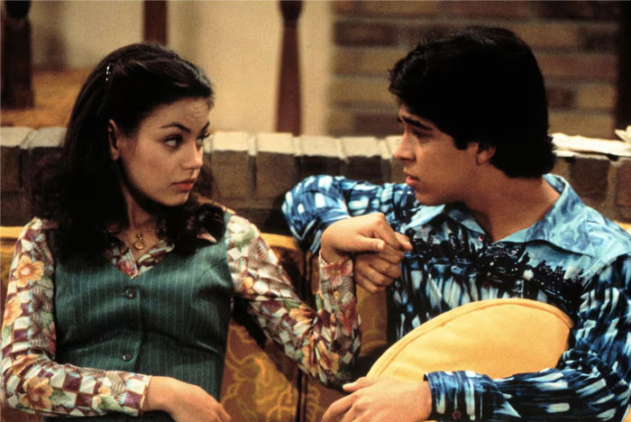 TV couple on a couch, gazing at each other, illustrating less chemistry.