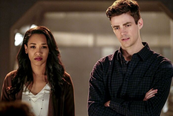 TV couple standing side by side, looking serious, lacking chemistry.