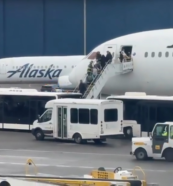 Seattle airport collision scene, emergency response vehicles and passengers disembarking. Seattle airport collision scene, emergency response vehicles and passengers disembarking.