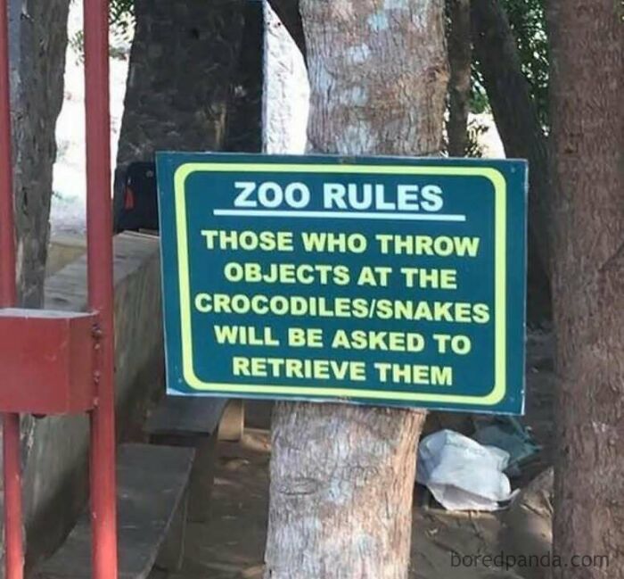 Zoo sign warning visitors not to throw objects at crocodiles or snakes, adding humor to internet memes.