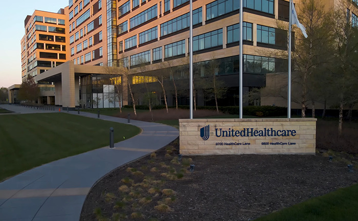 UnitedHealthcare office building exterior with signage in the foreground. UnitedHealthcare office building exterior with signage in the foreground.