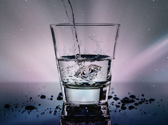 A diamond in a glass of water with reflections and splashes, symbolizing an unpopular opinion poll.