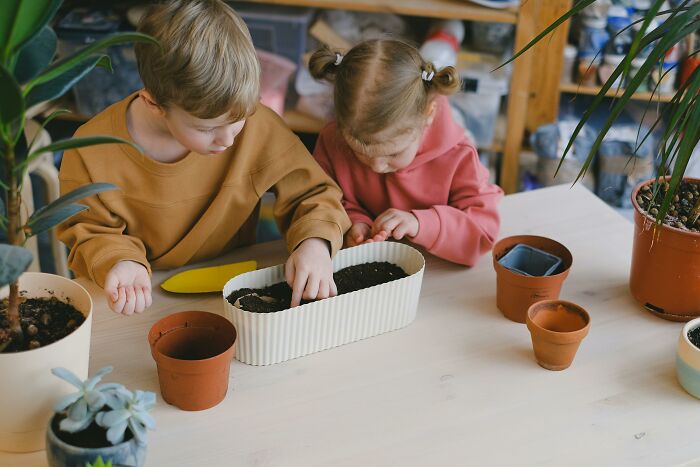 Kids planting in pots, exploring Valentine's gift ideas for children.