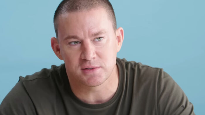 Man in a green shirt against a blue background, related to pop culture moments.