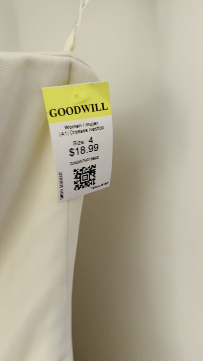 Goodwill store dress with a price tag, size 4, linked to Carrie Bradshaw's famous wedding dress.