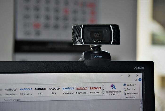 Webcam mounted on a computer monitor, illustrating a multi-functional item for a minimalist lifestyle.