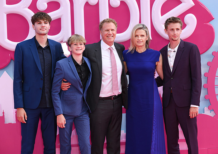 Will Ferrell and his family in formal attire at a pink-themed event, smiling for the camera.