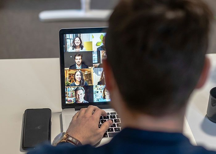 Person on laptop during virtual meeting, discussing toxic workplace dynamics.