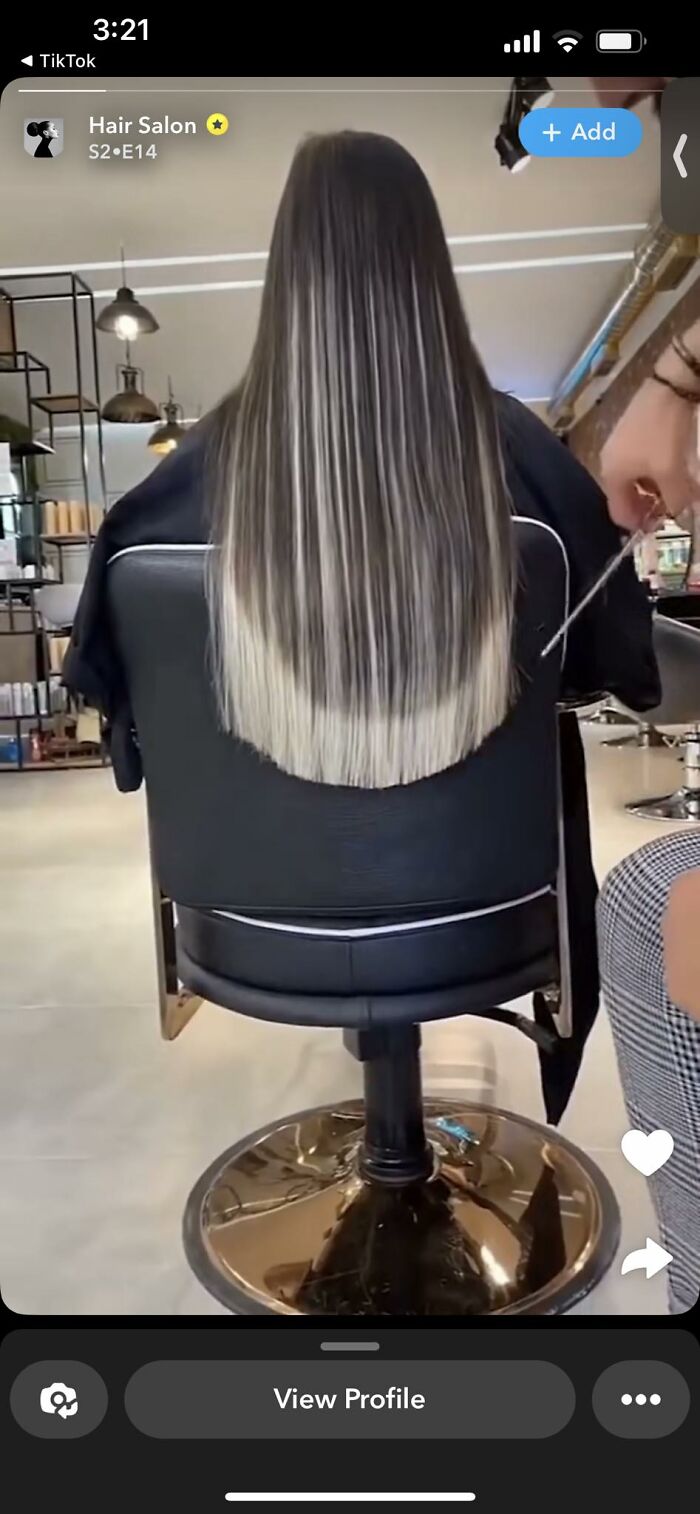 Hair fail with uneven layers as seen from the back in a salon setting.