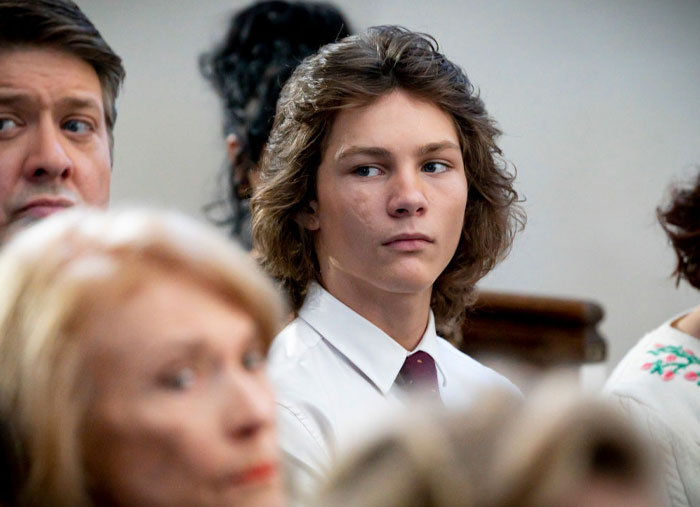 Young Sheldon cast member Montana Jordan in a formal setting, wearing a white shirt and tie, looking to the side.