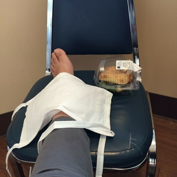 Bare foot propped on a chair with a wrapped sandwich beside it, illustrating Valentines Day fails.