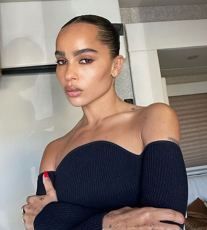 Woman in a black off-shoulder top with sleek hair, linked to Jason Momoa's publicity.