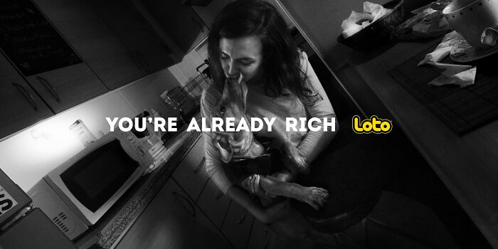 Woman embracing dog in a kitchen, conveying "You're Already Rich" message.