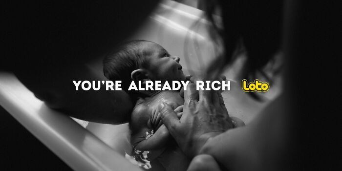 Black and white photo of a baby being gently bathed, with the text "You&rsquo;re Already Rich" overlayed.
