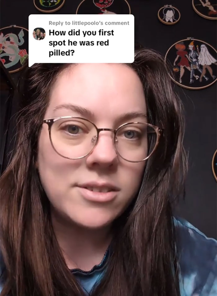 Woman discussing misogynistic beliefs and red-pill ideology in a video response, wearing glasses and a blue shirt. Woman discussing misogynistic beliefs and red-pill ideology in a video response, wearing glasses and a blue shirt.