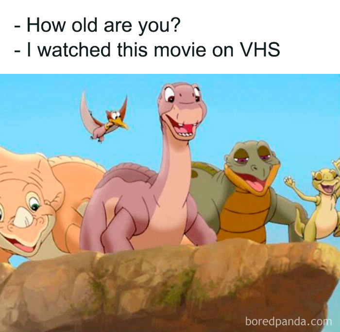 Cartoon dinosaurs on a rock with text about watching their movie on VHS, invoking nostalgia.