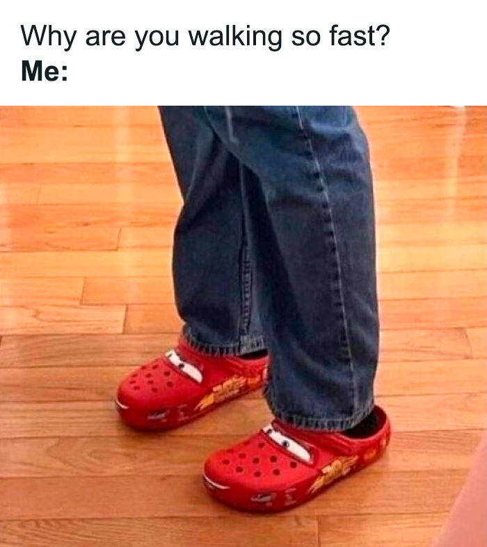 Person in jeans wearing red cartoon-themed Crocs, evoking nostalgia.
