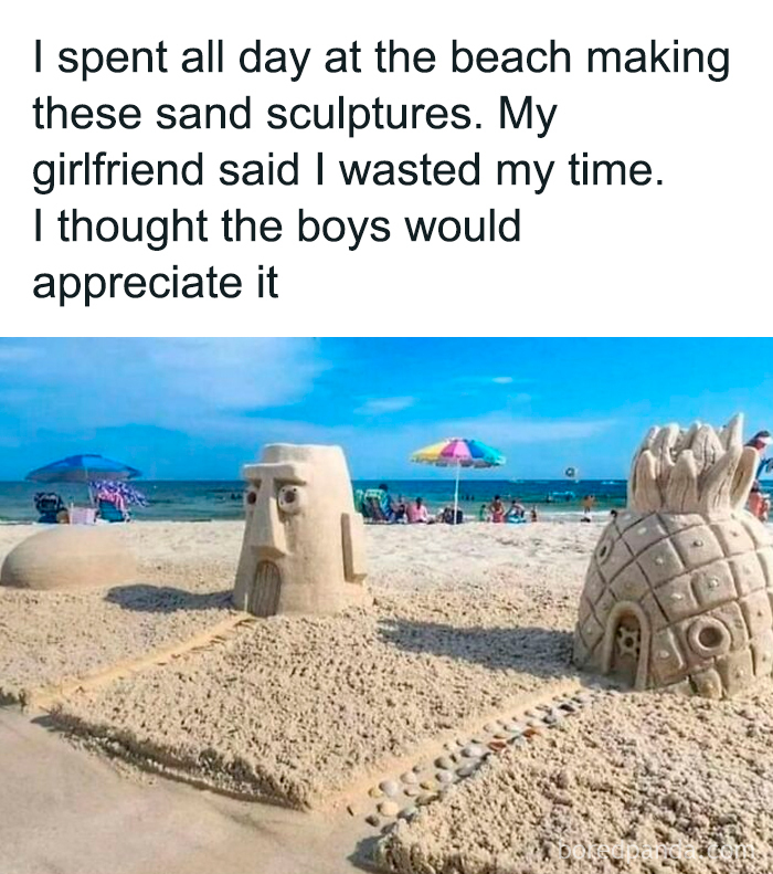 Sand sculptures of cartoon houses on a beach, with colorful umbrellas and people in the background, evoking nostalgic memories.